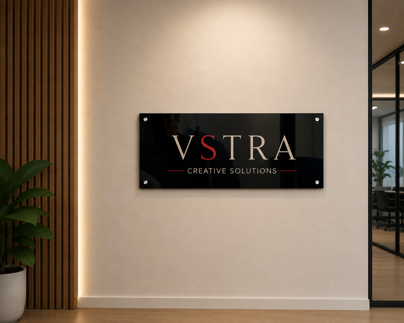 Black acrylic office signage with VSTRA Creative Solutions logo